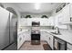 Modern kitchen featuring stainless steel appliances, white cabinets, and sleek countertops at 5801 Oyster Catcher Dr. # 1214, North Myrtle Beach, SC 29582
