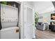 Convenient laundry area with stackable washer and dryer adjacent to a living space with modern decor at 5801 Oyster Catcher Dr. # 1214, North Myrtle Beach, SC 29582