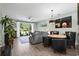 Open-concept living room and dining area with hardwood floors and lots of natural light at 5801 Oyster Catcher Dr. # 1214, North Myrtle Beach, SC 29582