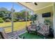 Cozy screened porch with comfortable seating and views of the lush green lawn and surrounding trees at 5801 Oyster Catcher Dr. # 1214, North Myrtle Beach, SC 29582
