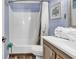 Well-lit bathroom features shower-tub combo, wood-look flooring, and blue paneled walls at 6000 N North Ocean Blvd. # 329, North Myrtle Beach, SC 29582