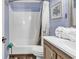 Well-lit bathroom features shower-tub combo, wood-look flooring, and blue paneled walls at 6000 N North Ocean Blvd. # 329, North Myrtle Beach, SC 29582