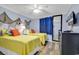 Cozy bedroom with yellow bedding, coastal decor, and a dresser at 6000 N North Ocean Blvd. # 329, North Myrtle Beach, SC 29582