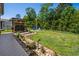 Private backyard features a grill area, lush lawn, and a charming pergola for outdoor entertaining at 757 Cherry Blossom Dr., Murrells Inlet, SC 29576