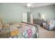 Bright bedroom with soft green walls, a ceiling fan, and a comfortable sitting area at 757 Cherry Blossom Dr., Murrells Inlet, SC 29576