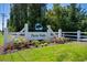 Welcome to Twin Oaks! Entrance sign beautifully landscaped with colorful flowers and lush greenery at 757 Cherry Blossom Dr., Murrells Inlet, SC 29576