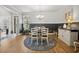 Stylish dining room featuring wainscoting, a round table, and a decorative seashell rug at 757 Cherry Blossom Dr., Murrells Inlet, SC 29576