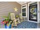 Charming front porch with rocking chairs, a floral rug, and a decorative wreath at 757 Cherry Blossom Dr., Murrells Inlet, SC 29576