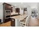 Spacious kitchen featuring dark wood cabinets, granite counters, and a large center island with seating at 757 Cherry Blossom Dr., Murrells Inlet, SC 29576