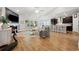 Bright living room with wood floors, a fireplace, and an open floor plan into the kitchen at 757 Cherry Blossom Dr., Murrells Inlet, SC 29576