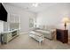 Comfortable living room with a neutral color scheme, large windows, and cozy furniture at 757 Cherry Blossom Dr., Murrells Inlet, SC 29576