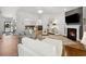 Inviting living room with a fireplace, gray sofa, and views into adjacent dining area at 757 Cherry Blossom Dr., Murrells Inlet, SC 29576