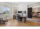 Bright home office featuring hardwood floors, modern computer setup, and large windows at 757 Cherry Blossom Dr., Murrells Inlet, SC 29576