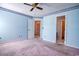 Bedroom showcases light blue walls, ceiling fan, and carpeting at 802 Mockingbird Ct., Murrells Inlet, SC 29576