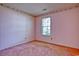 Bedroom with pink walls and carpet, a single window providing natural light at 802 Mockingbird Ct., Murrells Inlet, SC 29576