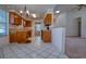 Well-lit kitchen featuring light counter tops, tiled floors, and an adjoining living space at 802 Mockingbird Ct., Murrells Inlet, SC 29576