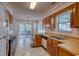 Traditional kitchen with wood cabinets, white appliances, tile floors, and sliding glass doors to a screened porch at 802 Mockingbird Ct., Murrells Inlet, SC 29576
