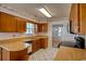 Kitchen featuring wood cabinets, white appliances, and ample counter space at 802 Mockingbird Ct., Murrells Inlet, SC 29576