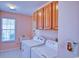 Laundry room with wood cabinets, large window and utility sink at 802 Mockingbird Ct., Murrells Inlet, SC 29576
