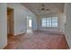 Living room with vaulted ceiling, ceiling fan, and pink carpet, connected to another room at 802 Mockingbird Ct., Murrells Inlet, SC 29576