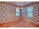 This living room features two windows and colorful floral wallpaper at 802 Mockingbird Ct., Murrells Inlet, SC 29576