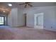 Living room featuring vaulted ceiling, ceiling fan, natural light from windows, and pink carpet at 802 Mockingbird Ct., Murrells Inlet, SC 29576