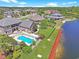 Aerial view of the lakefront home featuring an in-ground pool, dock and lush landscaping at 8029 Wacobee Dr., Myrtle Beach, SC 29579