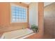 Bathroom showcasing a soaking tub and walk-in shower with neutral tile and a window at 8029 Wacobee Dr., Myrtle Beach, SC 29579