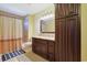 This bathroom has a shower/tub combo, with a vanity, wall cabinet, and neutral color palette at 8029 Wacobee Dr., Myrtle Beach, SC 29579