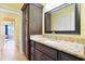 This bathroom has a large granite vanity with dark wood cabinets and a decorative mirror at 8029 Wacobee Dr., Myrtle Beach, SC 29579