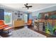 This blue bedroom features two orange swivel chairs, a wooden dresser, and a play tent at 8029 Wacobee Dr., Myrtle Beach, SC 29579
