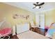 This bright bedroom features wood floors, a white dresser, and a hanging chair with pink cushion at 8029 Wacobee Dr., Myrtle Beach, SC 29579