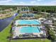 Large resort-style pool with lounge chairs, pergolas and a lakefront view at 8029 Wacobee Dr., Myrtle Beach, SC 29579