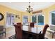 Bright dining room with chandelier, pool view, and space for a large dining table at 8029 Wacobee Dr., Myrtle Beach, SC 29579