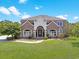 Beautiful two-story brick home with a manicured lawn and arched entryway at 8029 Wacobee Dr., Myrtle Beach, SC 29579
