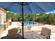 Backyard view with dining set, outdoor grill and outdoor fireplace at 8029 Wacobee Dr., Myrtle Beach, SC 29579