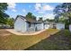 Exterior view of the home featuring blue siding, black shutters, and mature trees at 844 Wachesaw Rd., Murrells Inlet, SC 29576