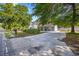 Street view of the property with a long driveway leading to the charming blue house at 844 Wachesaw Rd., Murrells Inlet, SC 29576