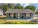 Charming single-story home featuring a covered front porch, blue siding, and well-manicured landscaping at 844 Wachesaw Rd., Murrells Inlet, SC 29576