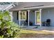 Inviting front porch with decorative columns, seating, and a clear view of the home's entrance at 844 Wachesaw Rd., Murrells Inlet, SC 29576