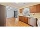 Kitchen featuring wood cabinets, stainless steel dishwasher and open view to breakfast area at 844 Wachesaw Rd., Murrells Inlet, SC 29576