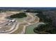 Aerial view of a new construction community with ponds, trees, and single-Gathering homes under construction at 853 Farmers Passage Loop, Loris, SC 29569
