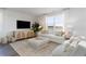 Bright living room with neutral decor, large window, and stylish furnishings, creating a cozy atmosphere at 858 Farmers Passage Loop, Loris, SC 29569
