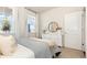 Well-lit bedroom showcasing a comfortable bed, window, and a white dresser with round mirror at 861 Farmers Passage Loop, Loris, SC 29569