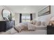 Serene bedroom with a comfortable bed, decorative mirror, and natural light at 862 Farmers Passage Loop, Loris, SC 29569
