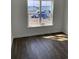 Bright bedroom with dark hardwood floors and a large window at 905 Inlet Keys St., Murrells Inlet, SC 29576