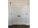 Classic white double doors with black hardware, providing a clean and modern closet storage solution at 905 Inlet Keys St., Murrells Inlet, SC 29576