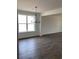 Bright dining room with hardwood floors, a modern chandelier, and large windows providing natural light at 905 Inlet Keys St., Murrells Inlet, SC 29576