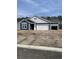 Charming single-story home with blue siding, white trim, two-car garage, and lovely architectural details at 905 Inlet Keys St., Murrells Inlet, SC 29576