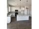 Modern kitchen with white cabinets, stainless steel appliances, central island, and stylish pendant lights at 905 Inlet Keys St., Murrells Inlet, SC 29576